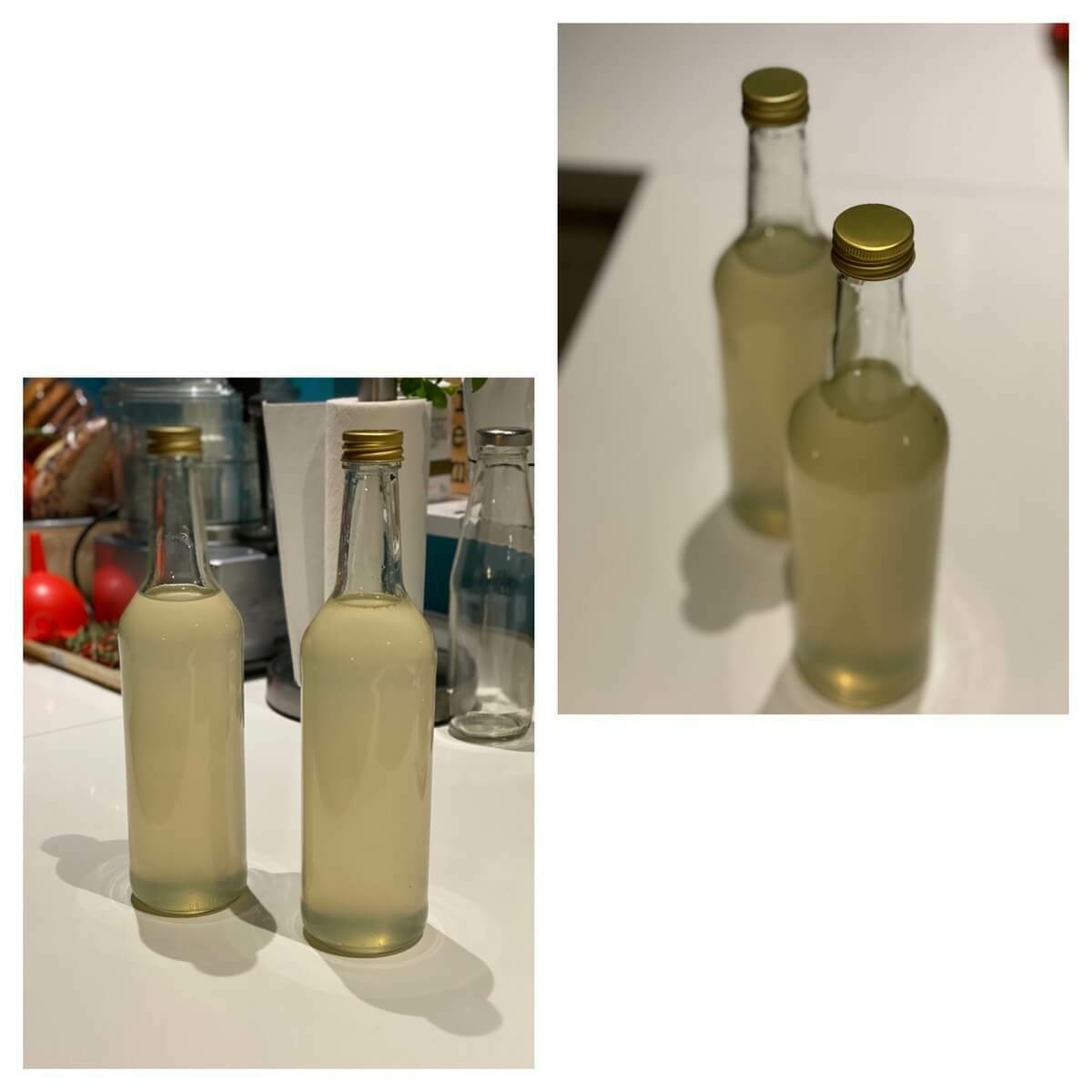 Twee flessen zelfgemaakte citroen-gemberlimonade op een aanrecht